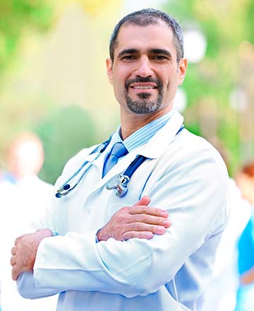 Мужчина врач со стетоскопом на шее в белом халате